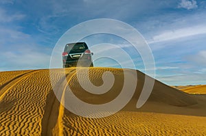 Desert safari on off-road vehicles. Sandy clubs, red-yellow sand.