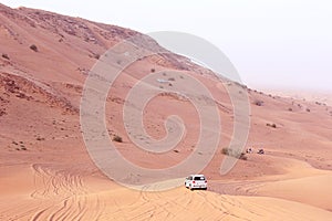 Desert safari vehicle in the middle of desert, desert mountain