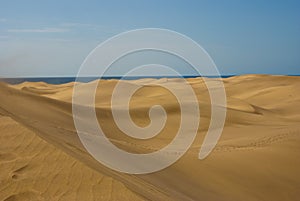 Desert sand dunes with sea at horizont