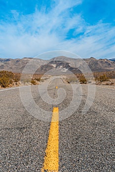 Desert scenic road in Death Valley with mountain backdrop, California, USA. Amazing natural panorama