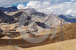 Desert with stone mountains landscape with electricity and telecommunication towers in countryside of India