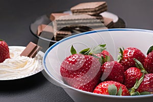 Desert with strawberries on a black table