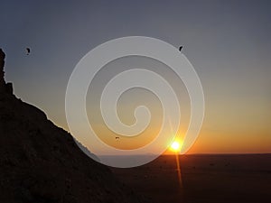 Desert Sunset and paragliding at Hajjar Mountain range, United Arab Emirates