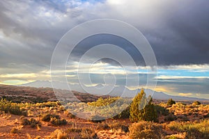 The desert under stormy skies in Arches National Park.