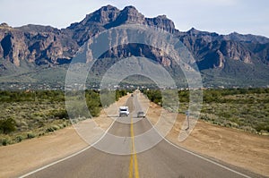 Desert wilderness road leading to mountain.