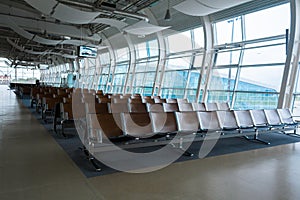 Deserted airport terminal. Rows of empty seats in the waiting room