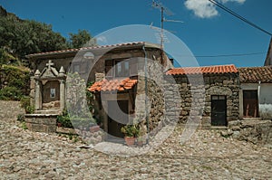 Deserted alley and old small house with stone walls