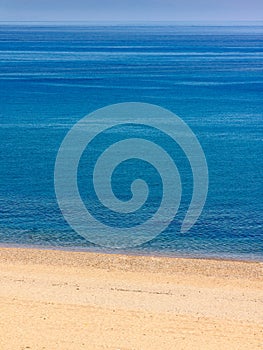 Deserted beach with brilliant blue sea