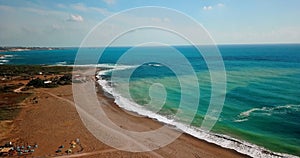 Deserted beach with crystal clear water on shores of Mediterranean Sea, aerial view sunset