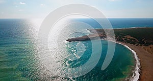 Deserted beach with crystal clear water on shores of Mediterranean Sea, aerial view sunset