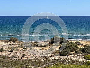 A deserted beach with its totally blue sky photo