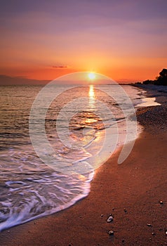 Deserted beach at sunset photo