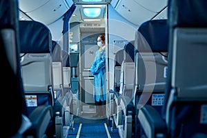 The deserted cabin of the plane, near the cockpit, a stewardess in a medical mask and a dressing gown will greet passengers. Air