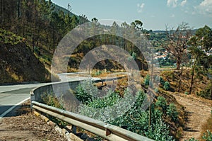 Deserted curve road through hilly landscape