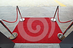 Deserted elegant reception red carpet with ropes barrier