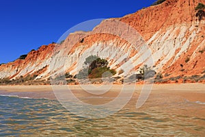 Deserted golden sandy beach in Olhos de Agua, Albufeira, Algarve, Portugal. photo