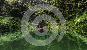 Deserted hut floating in a greeny lake