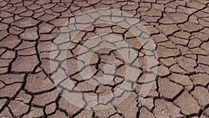 A deserted landscape with cracked ground of a parched lake
