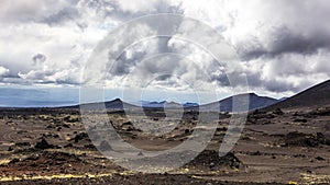 Deserted lifeless volcanic landscape near Volcano Tolbachik in the overcast weather. Kamchatka Peninsula, Russia