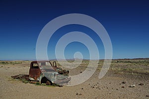 Deserted old Rusty car wreck deserted in the Namibia desert near death Valley signifying loneliness.