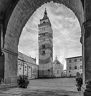 Almost deserted Piazza del Duomo framed by an arch of the Palazzo del Comune, Pistoia, Tuscany, Italy photo