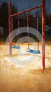 Deserted playground scene with a melancholic empty swing underlining isolation