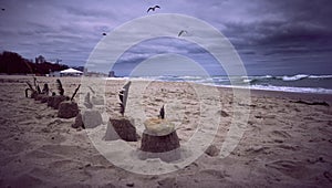 Deserted seashore with figurines on the sand and storm clouds in the background in Odessa Ukraaine