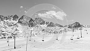 Deserted ski slopes in the middle of the coronavirus pandemic, view of the cable cars in the middle of the mountains