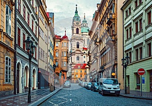 Deserted street with old house and view on tower from cathedral in prague