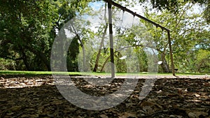 Deserted Swingset in Park Moving Fast