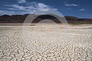 The deserted tokirs on ground are cracked from drought, the bottom of the lake is exposed, the water has evaporated from the heat