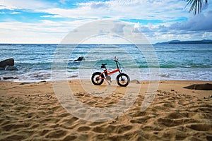 Deserted tropical beach and an electric bike. Thailand, Phuket