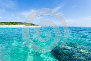 Deserted tropical island beach, clear blue water