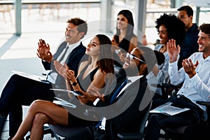 That deserves a round of applause. Cropped shot of a group of young businesspeople applauding during a seminar in the