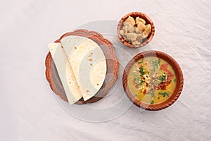 Desi breakfast, haleem, halim, dhaleem, halwa and chapatti served in dish isolated on background top view of bangladesi breakfast
