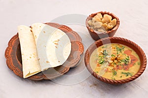 Desi breakfast, haleem, halim, dhaleem, halwa and chapatti served in dish isolated on background top view of bangladesi breakfast