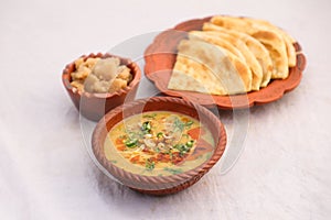 Desi breakfast, haleem, halim, dhaleem, halwa and paratha served in dish isolated on background top view of bangladesi breakfast