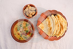 Desi breakfast, haleem, halim, dhaleem, halwa and paratha served in dish isolated on background top view of bangladesi breakfast