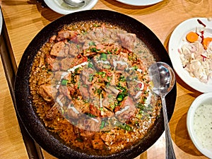 Desi butter chiken masala serverd in karahi top view of indian, pakistani karai food