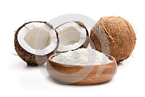 Desiccated coconut in wooden bowl isolated on white