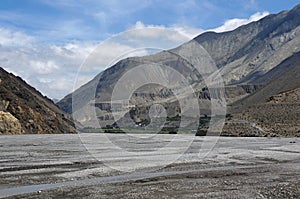 The desiccated riverbed of Kali Gandaki River, against the backdrop of the Himalayan mountains.