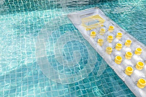 Design air mattress floating on clear swimming pool water