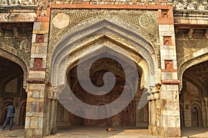 A design at bara gumbad monument at lodi garden or lodhi gardens in a city park from the side of the lawn at winter foggy morning