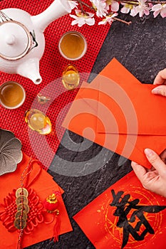 Design concept of Chinese lunar January new year - Woman holding, giving red envelopes ang pow, hong bao for lucky money, top