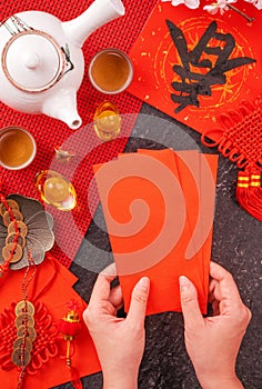 Design concept of Chinese lunar January new year - Woman holding, giving red envelopes ang pow, hong bao for lucky money, top