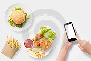 Design concept of mockup Using smartphone with burger, french fr