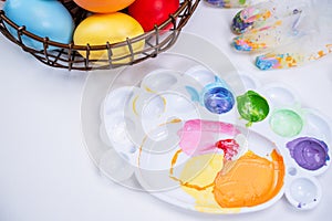 Design concept - Preparing for Easter celebration, painting Easter eggs with colorful Acrylic pigment color dyestuff in palette,