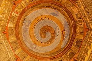 A design inside of bara gumbad monument at lodi garden or lodhi gardens in a city park from the side of the lawn at winter foggy