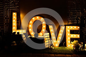 Design of the letters love glowing light bulb letters. concept of love, relationship, valentine`s day