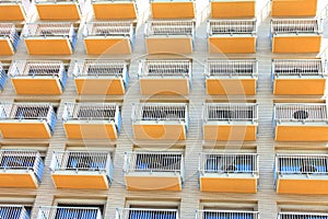 Modern European facade of multi-storey apartment building or hotel with many balconies